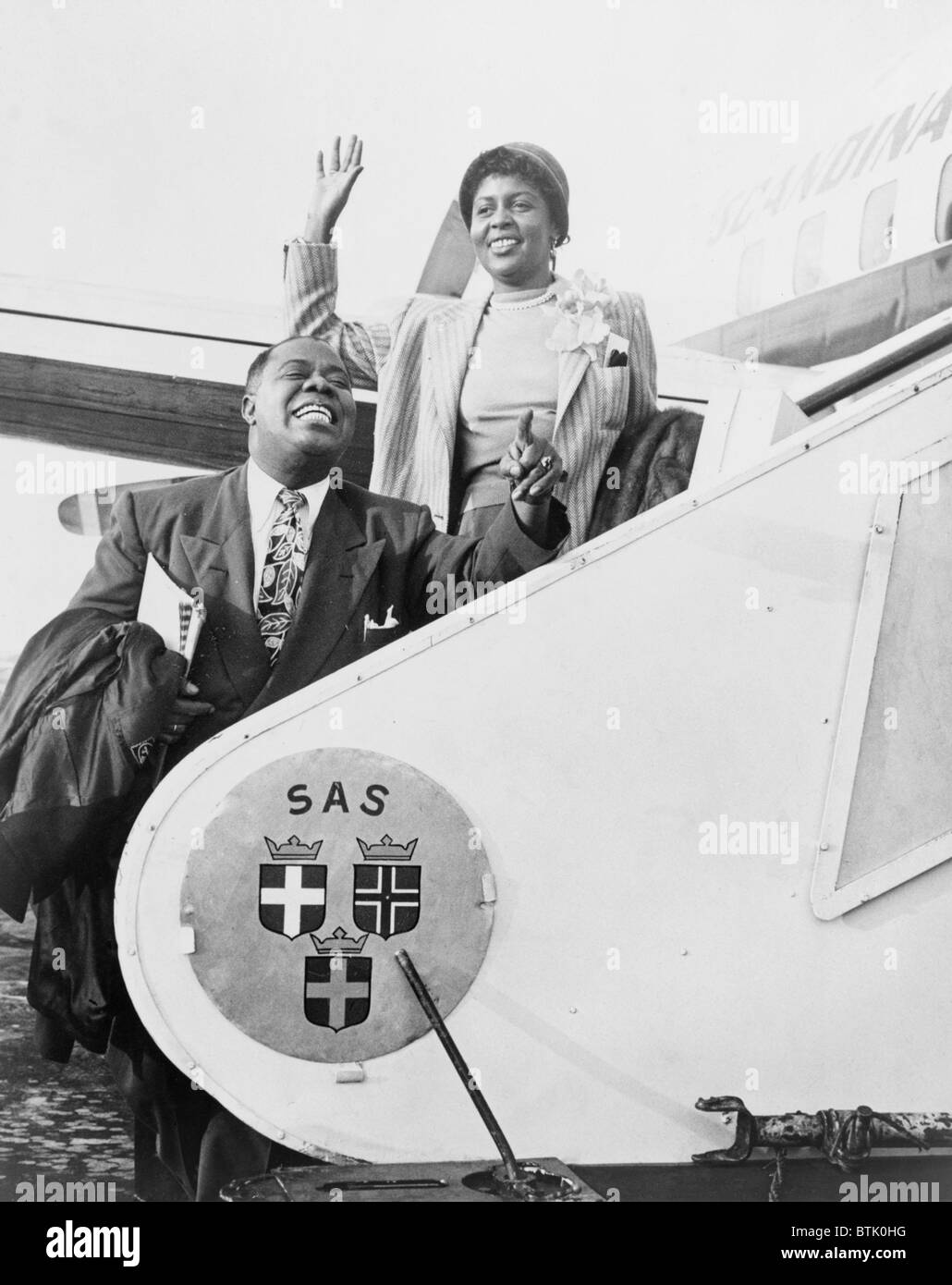 Louis Armstrong (1901-1971), African American Jazz musician, and his wife Lucille boarding airplane for Stockholm. 1952. Stock Photo