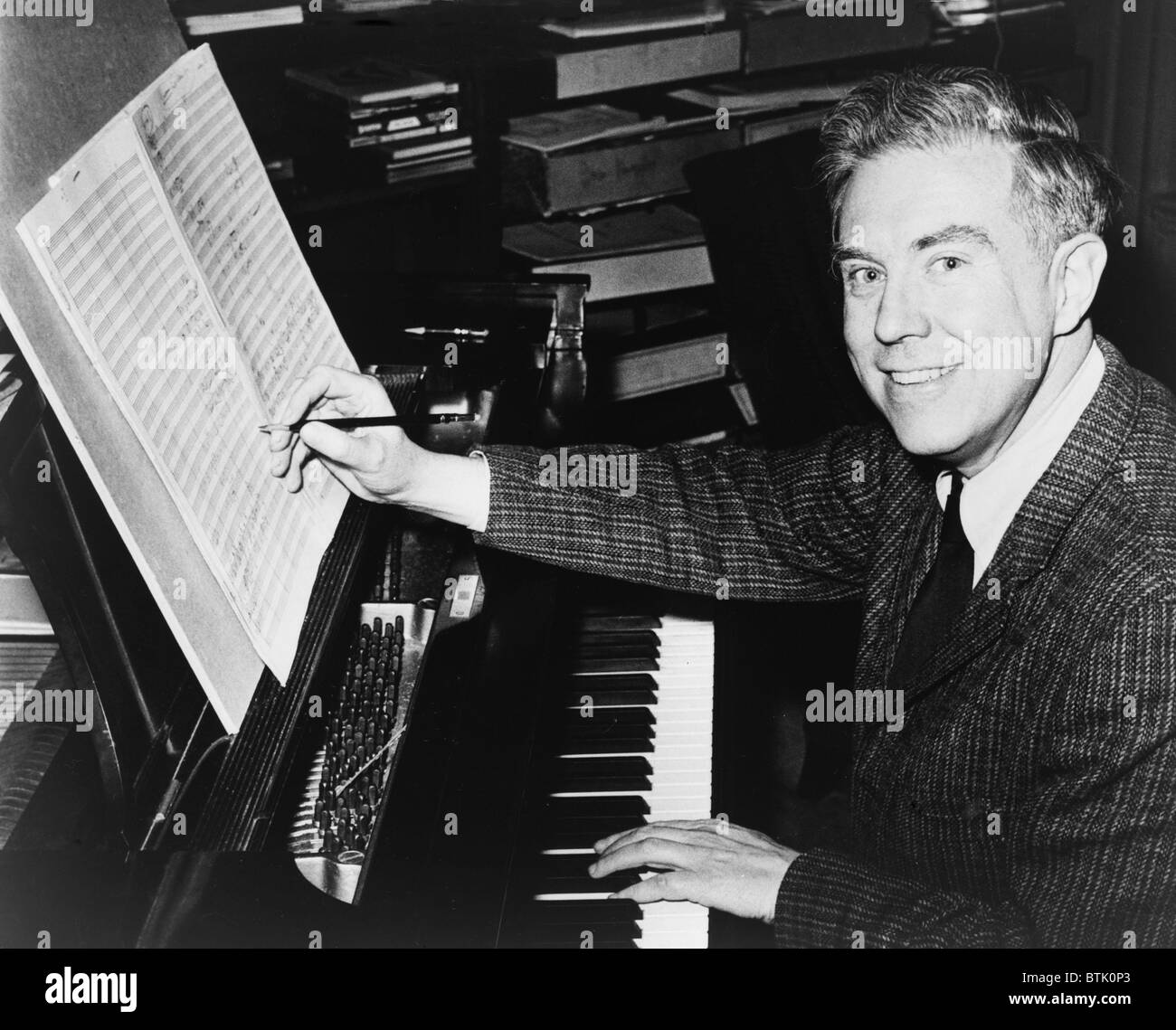 Elliott Carter (b. 1908), American composer seated at piano, editing sheet of music. During his long career, Carter won two Pulitzer Prizes (1960, 1973), a 1993 Grammy and in 2001, Yo-Yo Ma premiered his new CELLO CONCERTO. Stock Photo