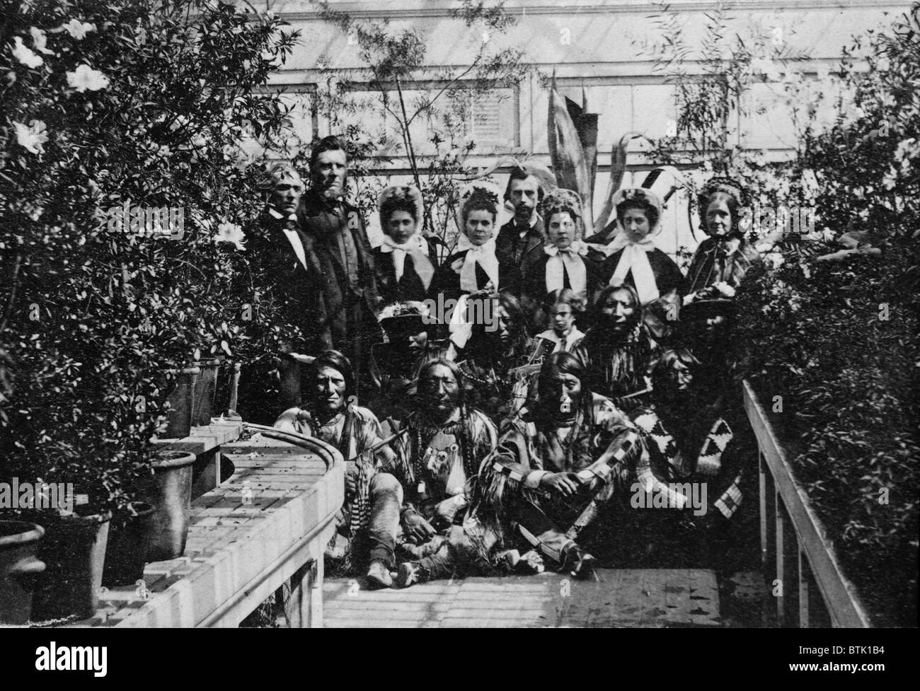 Mary Todd Lincoln (standing at far right) in a group photo with a Southern Plains Indian delegation taken in the White House Conservatory on March 27, 1863. Stock Photo