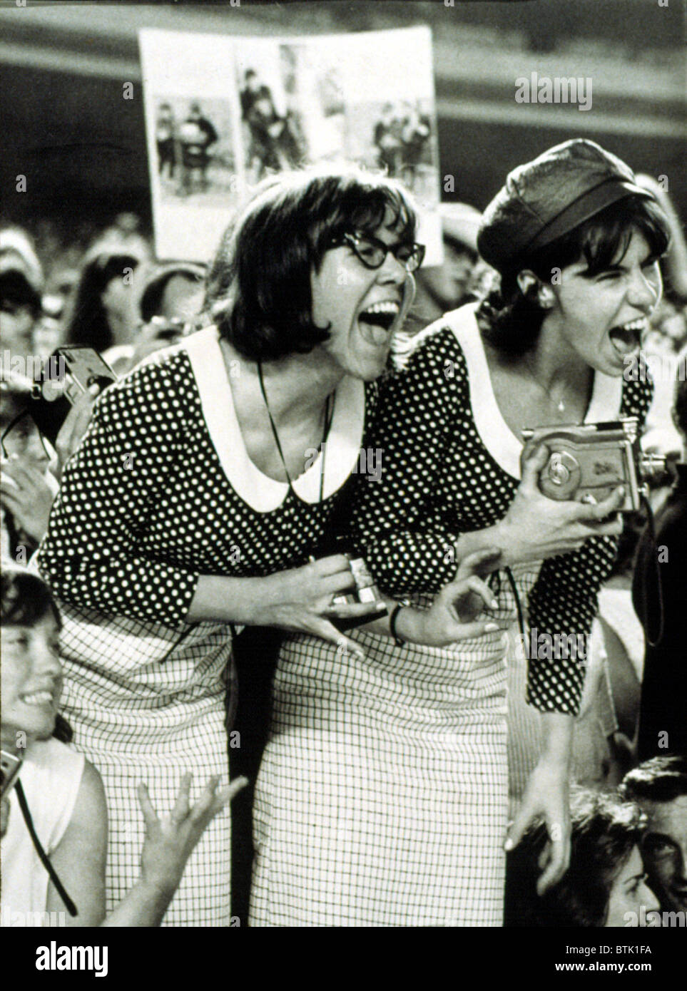 BEATLES FANS scream at a concert at Shea Stadium, NY, 8/15/65, displaying what is called, 'Beatlemania.' Stock Photo