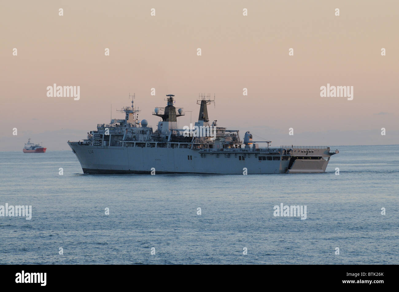 HMS Albion L14 outbound from Portsmouth England early evening light. The ship is a LPD Landing Platform Dock Stock Photo