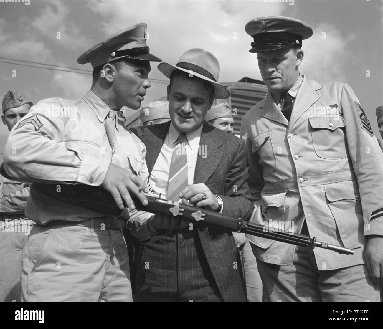 World War II, French L. Vineyard (left), at his army post, where welder George Woolslayer (center) and Aviation-radio Chief John Marshall Evans (right) learn about life in the Army, Pittsburgh, Pennsylvania, photograph by Alfred T. Palmer, August, 1942 Stock Photo