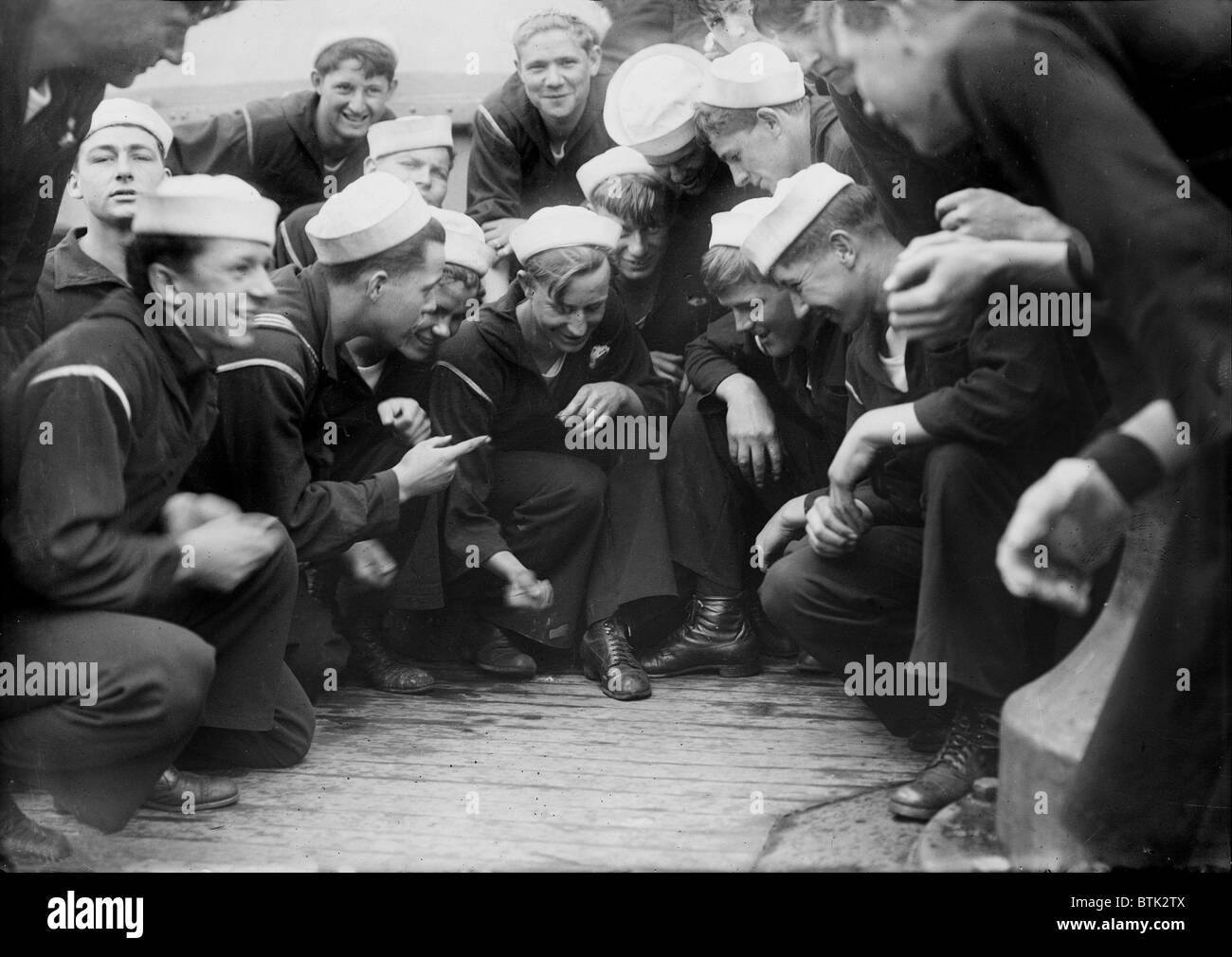 Sailors playing a dice game on the New York, original title: 'Shooting craps on New York', photograph circa 1900s-1930s Stock Photo