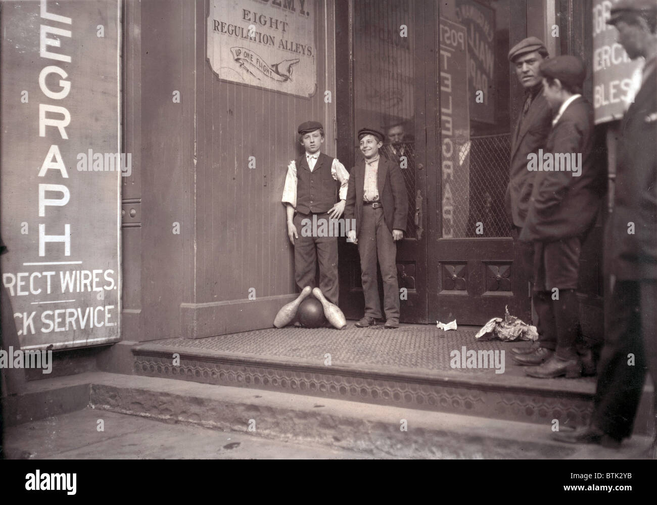 Child labor, bowling alley boys, from original caption: 'Many of these work until late at night.' New Haven, Connecticut, photograph by Lewis Wickes Hine, March, 1909 Stock Photo