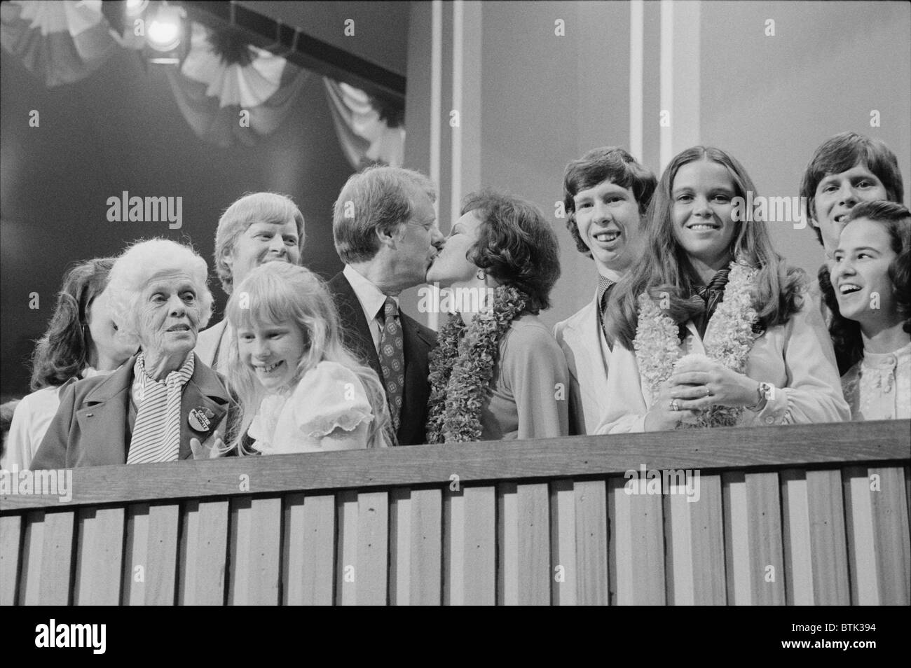 1976 Democratic Convention. Jimmy and Rosalynn Carter kissing, surrounded by family, including young daughter Amy and mother Lillian Carter. Stock Photo