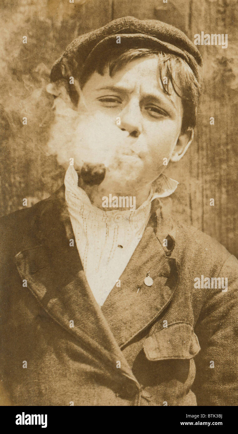 Portrait of boy smoking a pipe, original caption: 'A.M. Monday, newsies at Skeeter's branch They were all smoking.', St. Louis, Missouri, photograph by Lewis Wickes Hine, May 9, 1910 Stock Photo - Alamy