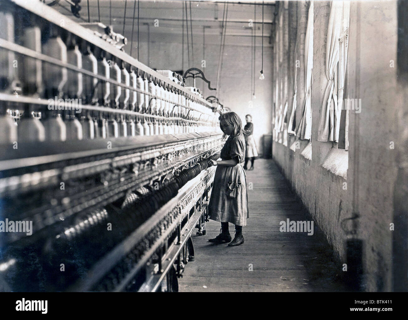 Child laborer portrayed by Lewis Hine in 1908.  Sadie Pfeifer worked in a cotton mill in South Carolina. Stock Photo