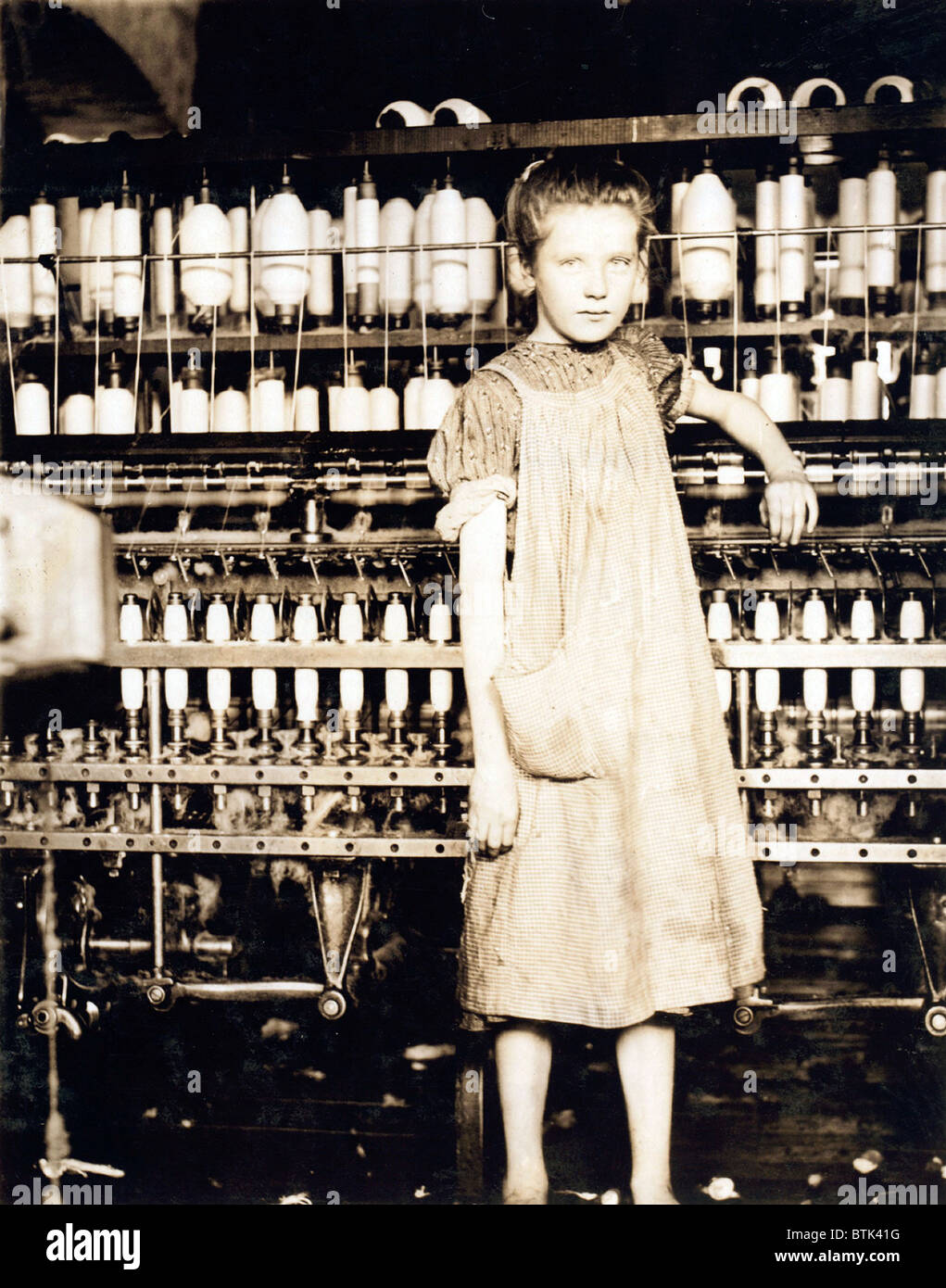 Child laborer portrayed by Lewis Hine in 1910. Twelve year old Addie Card, was a spinner in a Vermont cotton mill, and did not plan to go back to school. Stock Photo