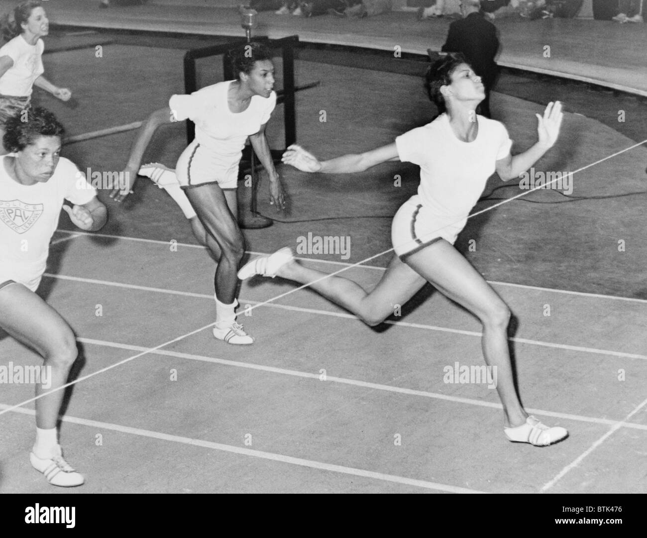 Wilma Rudolph (1940-1994) at the finish line during 50 yard dash at track meet in Madison Square Garden in 1961. Stock Photo