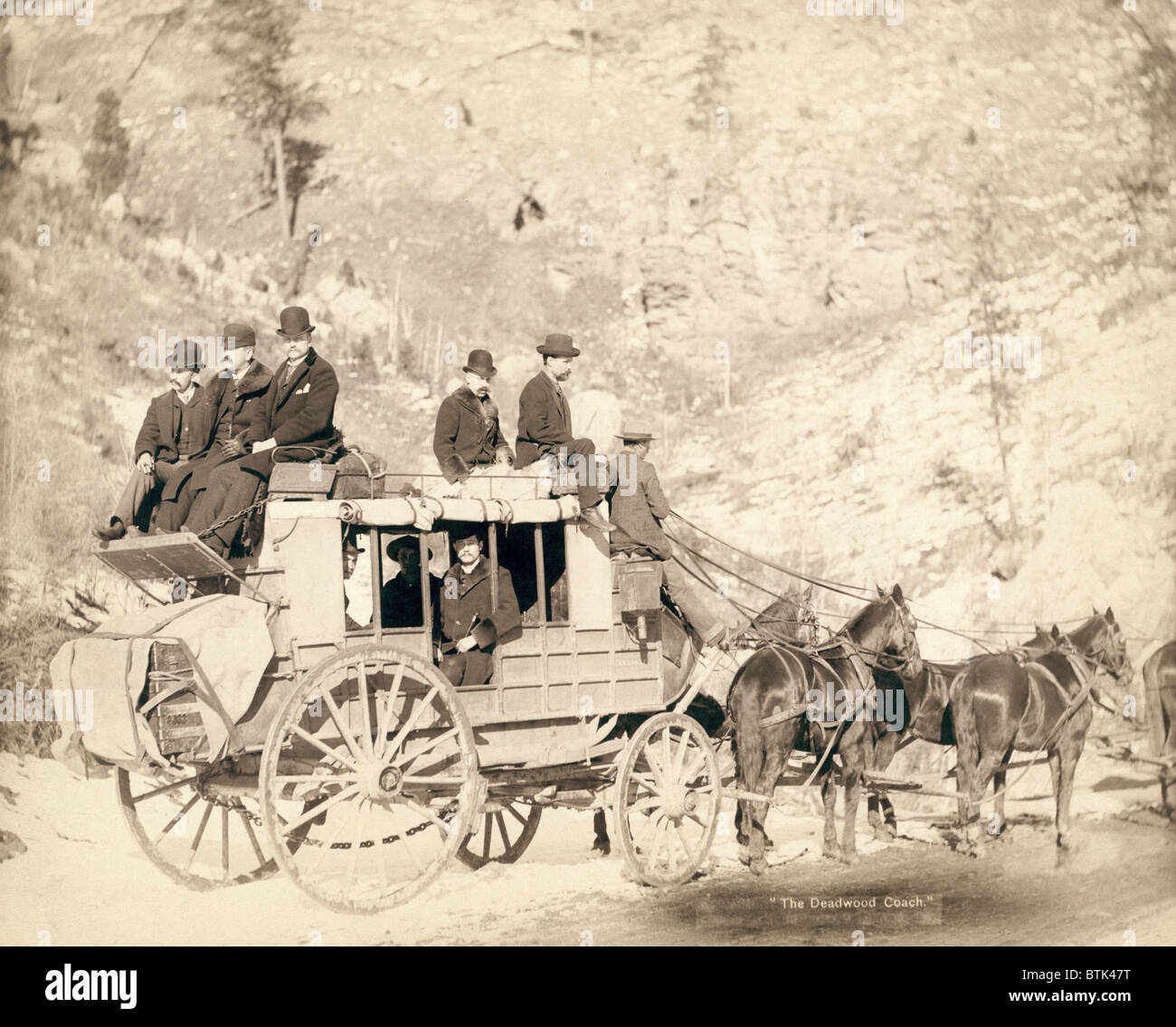 The Deadwood stagecoach fully loaded with nine formally dressed men ...