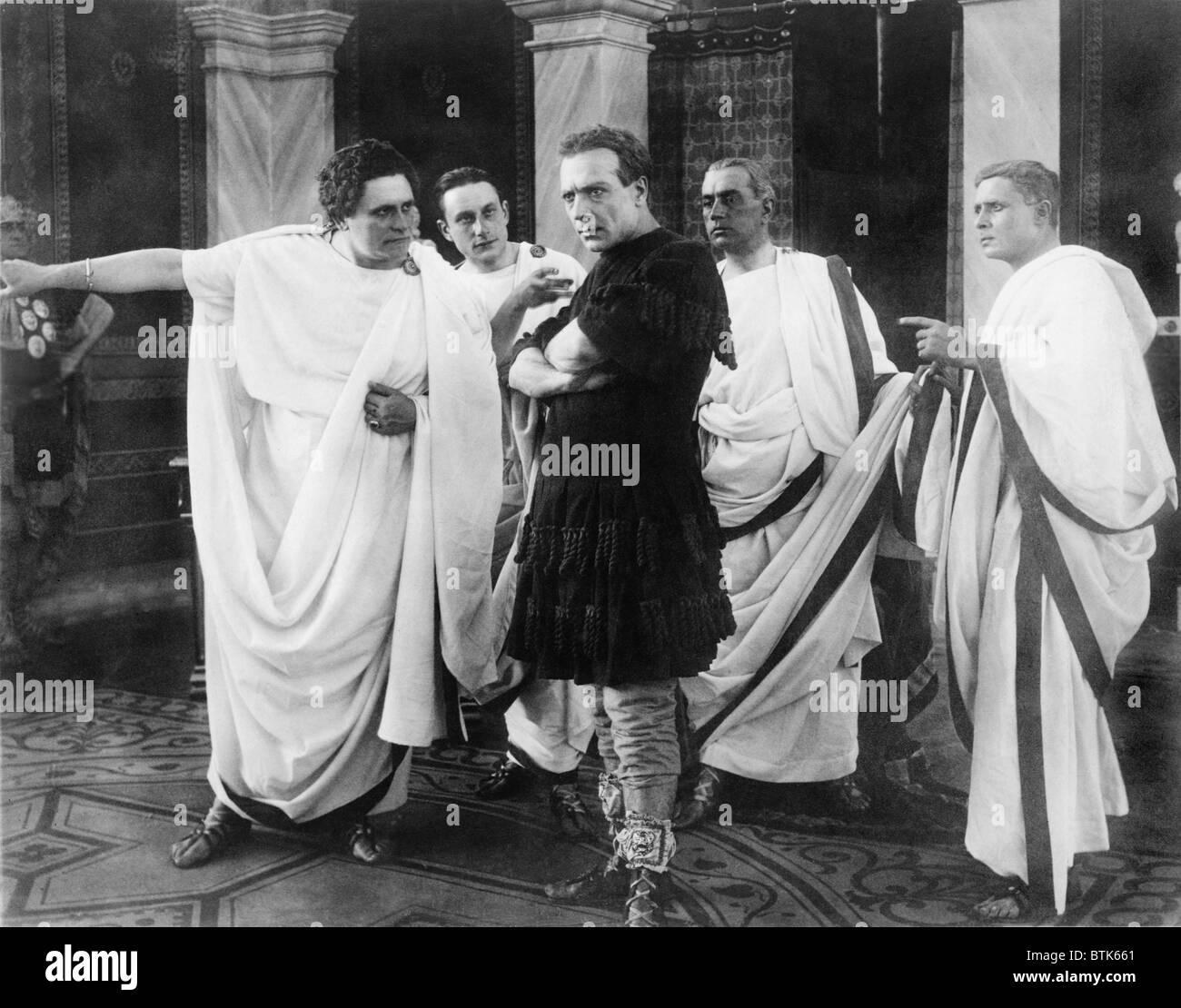 Amleto (Anthony) Novelli (1885-1924), Italian actor in a movie still from JULIUS CAESAR, 1914. Scene shows Novelli, as Caesar, surrounded by four Roman senators. Stock Photo