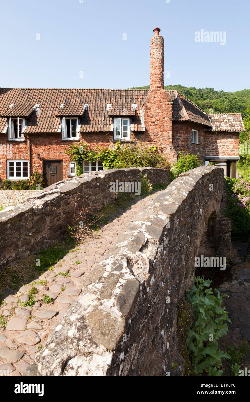 The ancient pack horse bridge over the shallow River Aller at Allerford, Exmoor, Somerset Stock