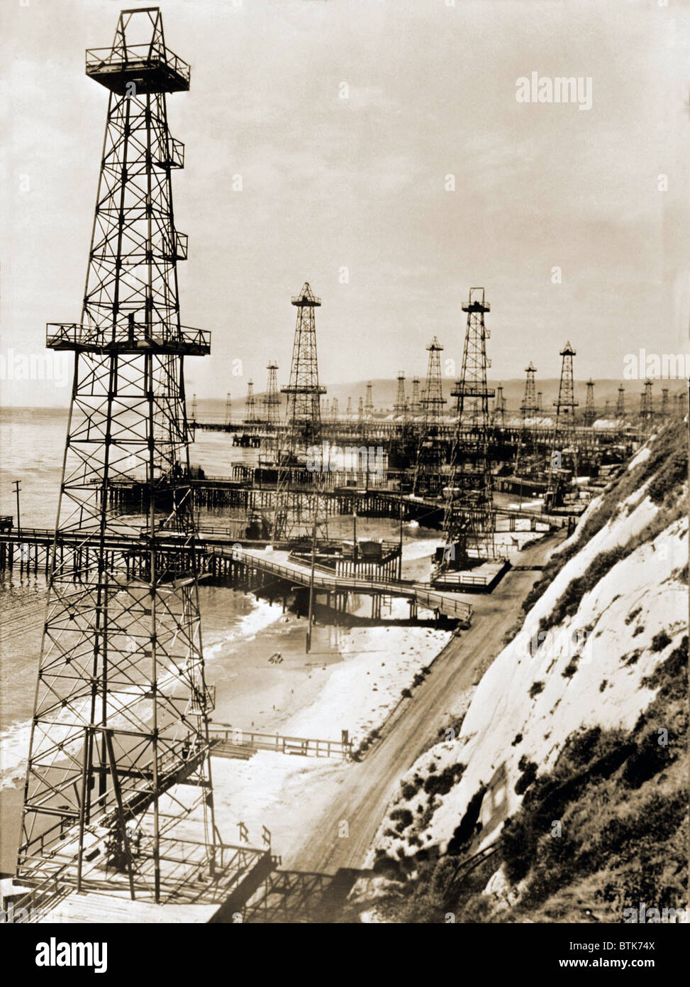 Oil well derricks on the beach along the California coast. Ca. 1944