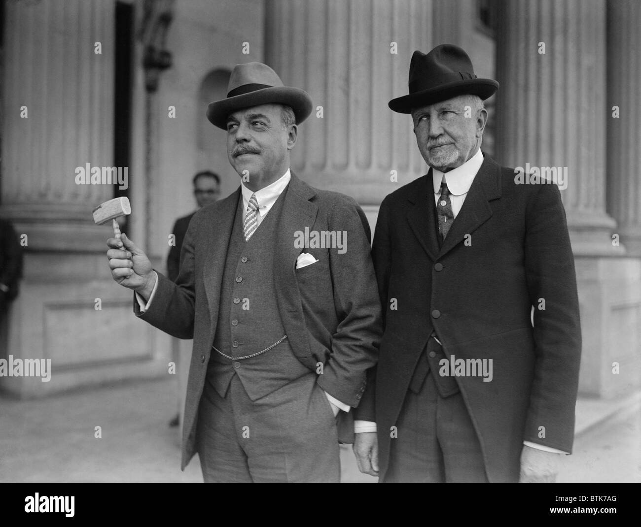 Frederick Gillette, leaving his position as Speaker of the House of Representative for a Senate seat, hands his gavel to Nicholas Longworth, the new Speaker. Feb. 28, 1925. Stock Photo