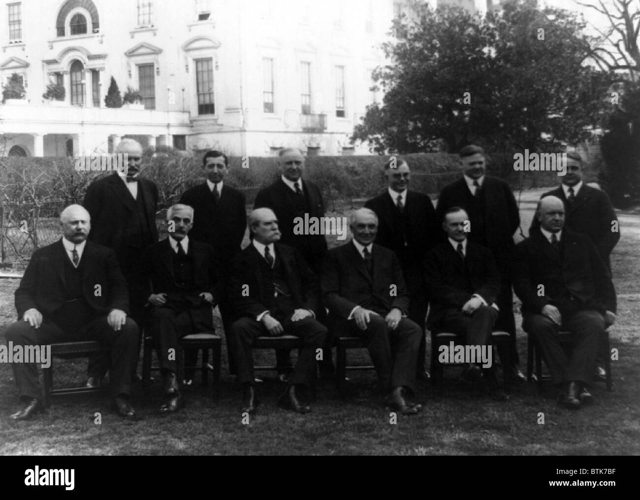 President Warren G. Harding and his cabinet posed on the White House Lawn in 1921. The strong members, Andrew Mellon, Herbert Hoover, and Charles Evans Hughes performed well. The weak and corrupt, notably Harry Daugherty and Albert Fall, ultimately served jail sentences for their activities. Stock Photo