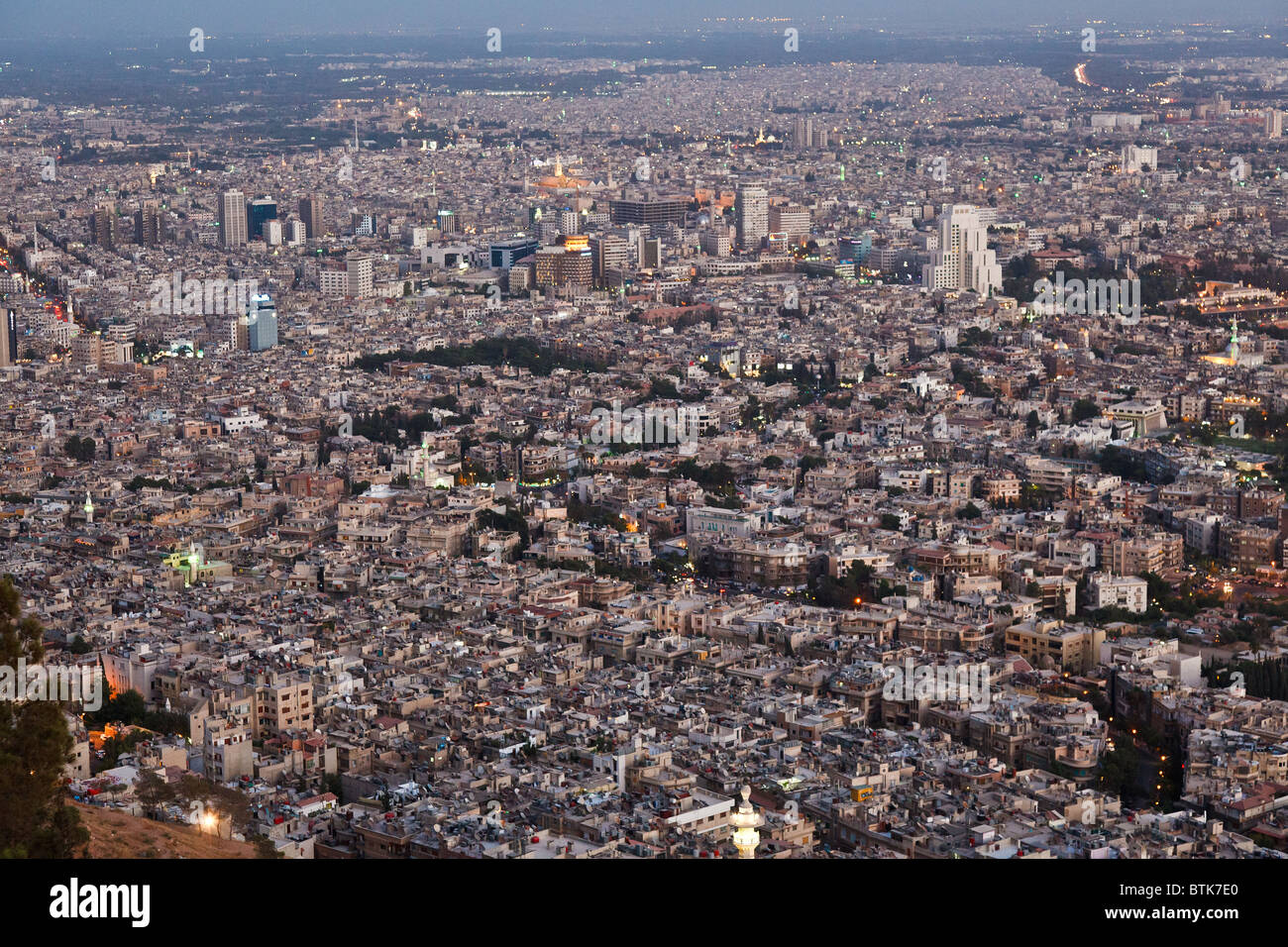 the lights of Damascus, syria, at dusk with the umayad mosque in the