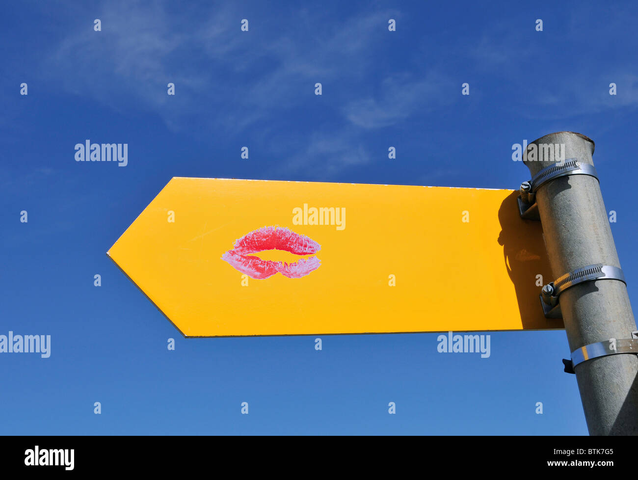 lipstick kiss printed on yellow sign Stock Photo - Alamy