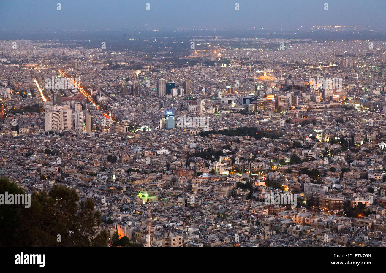 the lights of Damascus, syria,  at dusk  with the umayad mosque in the upper right Stock Photo