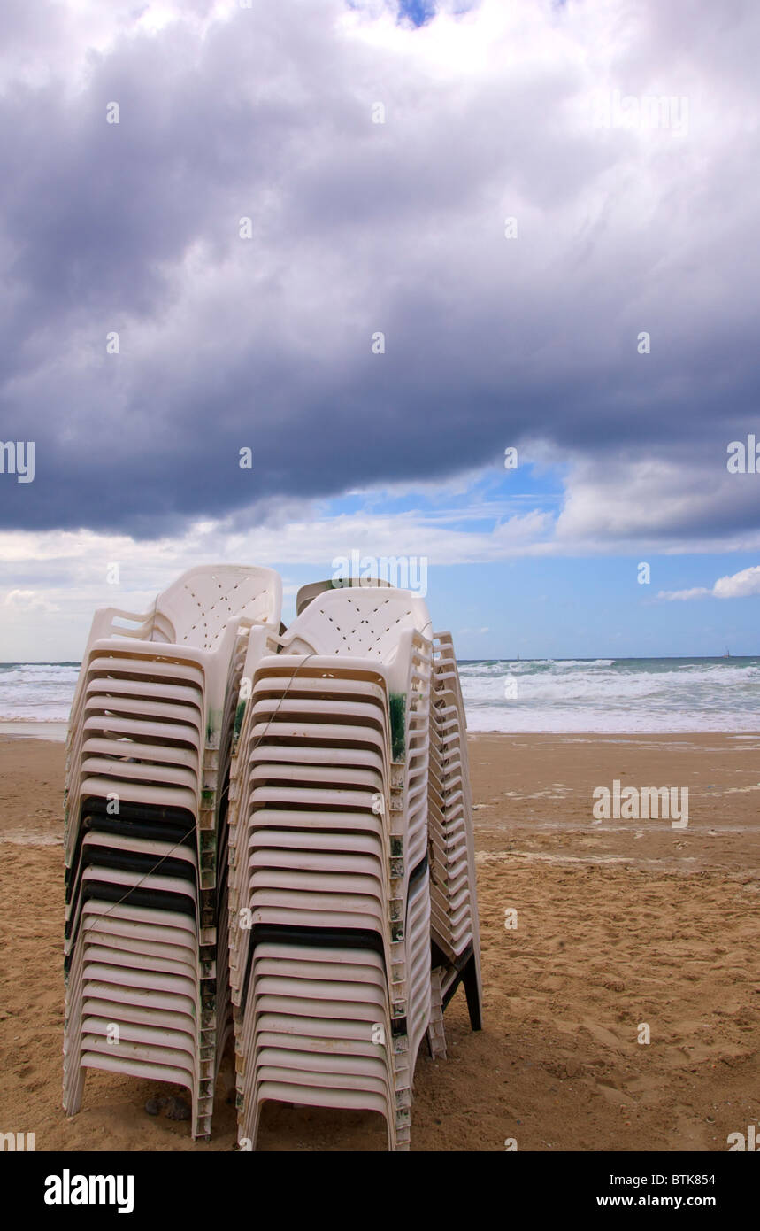 stacked beach chairs on a winter day Stock Photo