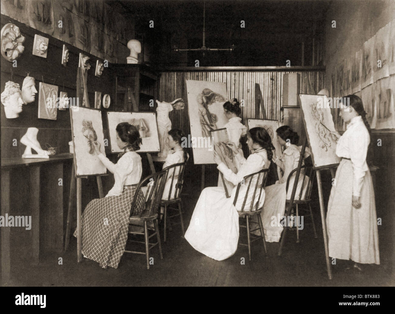 Six girls in art a high school art class drawing plaster casts of
