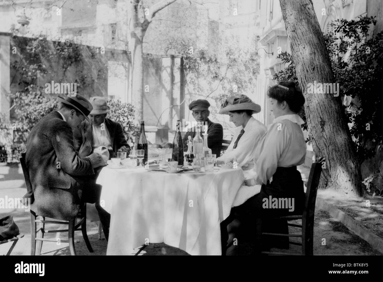 Francis Picabia (1879-1953), French painter, (center) with friends at an outdoor café. Ca. 1915. Stock Photo
