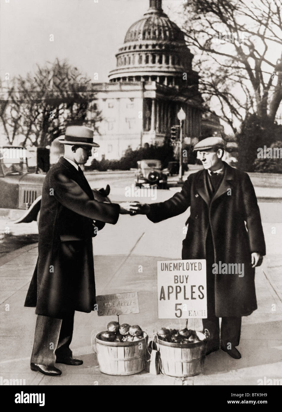 The Great Depression. Unemployed man sells apples near the Capitol in Washington D.C. As the Great Depression deepened in 1930, unemployed men obtained apples from the International Apple Shippers Association, to sell on the streets. 1930 Stock Photo