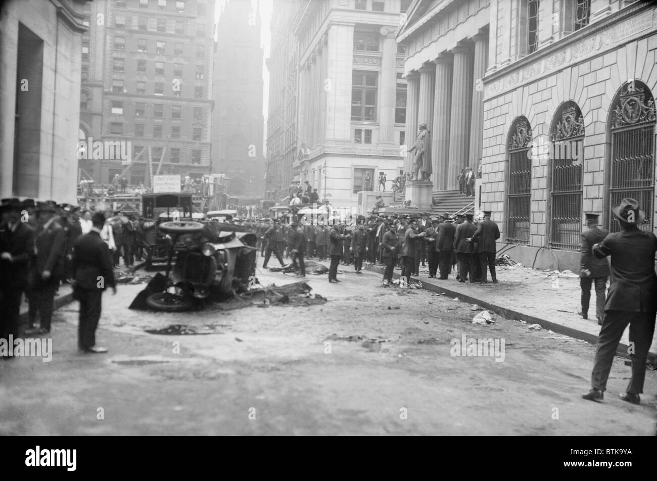 The Wall Street Bombing. Police, soldiers, and reporters at the scene of the Wall Street terrorist bombing, Sept. 16, 1920.The dead and injured people have been removed, leaving wrecked cars and a dead horse on Wall Street. Stock Photo