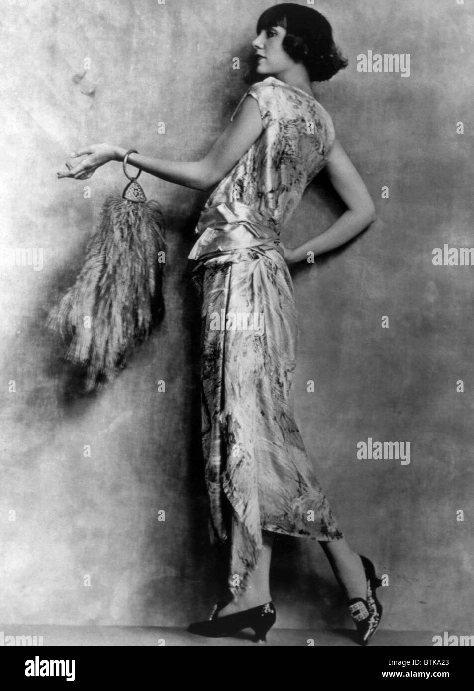 Evening gown of brocaded satin and feathered handbag, circa 1922. Photo: Courtesy Everett Collection Stock Photo