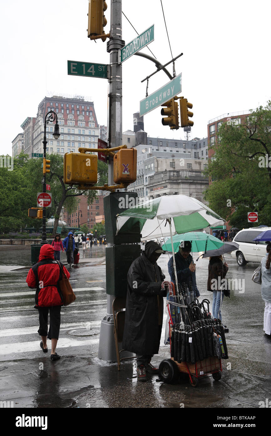 An umbrella seller on Broadway, New York City, USA Stock Photo
