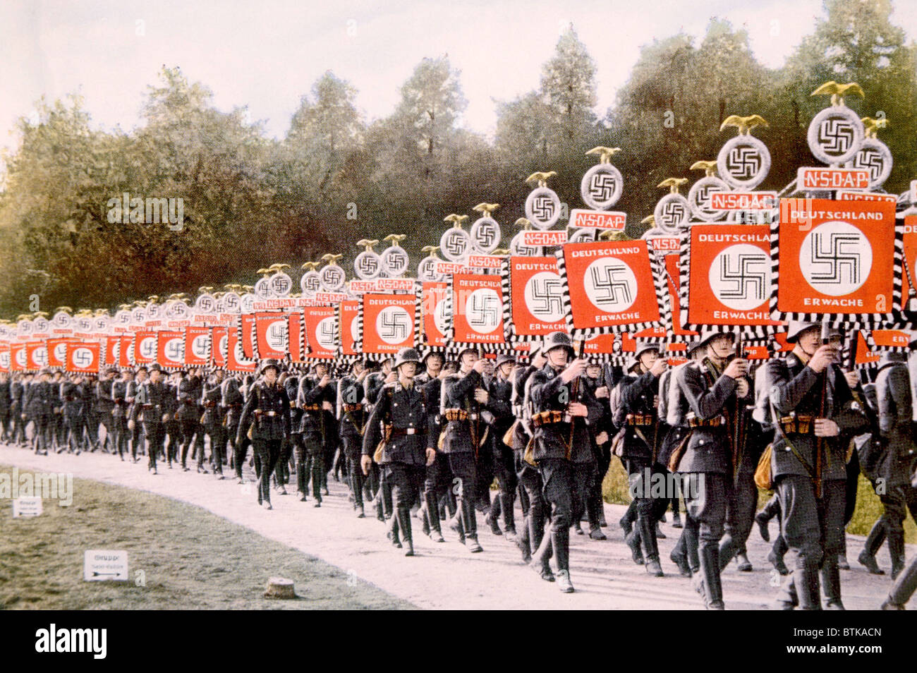 Nazi Germany, Nazi SS troops marching with victory standards at the Party Day rally in Nuremberg, 1933. Stock Photo