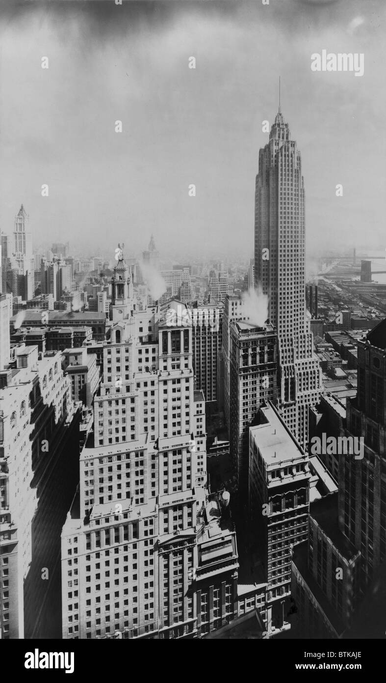 The slender 950 foot tower of 70 Pine Street (right mid-ground) was the last of the Jazz Age skyscrapers in Manhattan's Financial District. After the destruction of the World Trade Center, it became the third highest building in New York City. Photo ca. 1930. Stock Photo