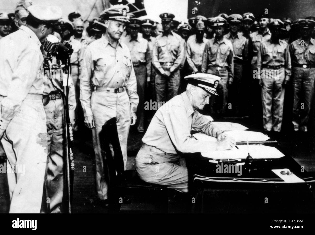 World War II, Admiral Nimitz signing Japanese surrender document aboard the U.S.S. Missouri, September 2, 1945. Stock Photo