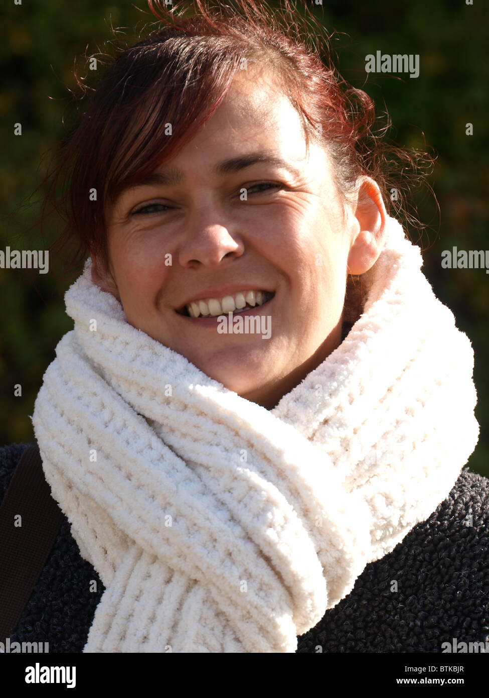 Mid thirties woman with big warm scarf, UK Stock Photo