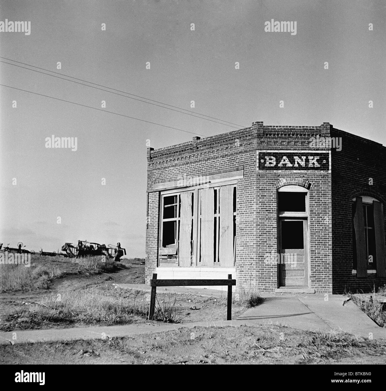 The Emergecy Banking Act of 3/9/1933, signed during the first week of FDR's presidency, temporarily closed down insolvent banks, and their reopening federal auditors determined them to be sound. One third of the country's banks, mostly local concerns, were not able to reopen, dotting the Great Depressin landscape with abandoned bank buildings. May 1936 photo by Arthur Rothstein. Stock Photo
