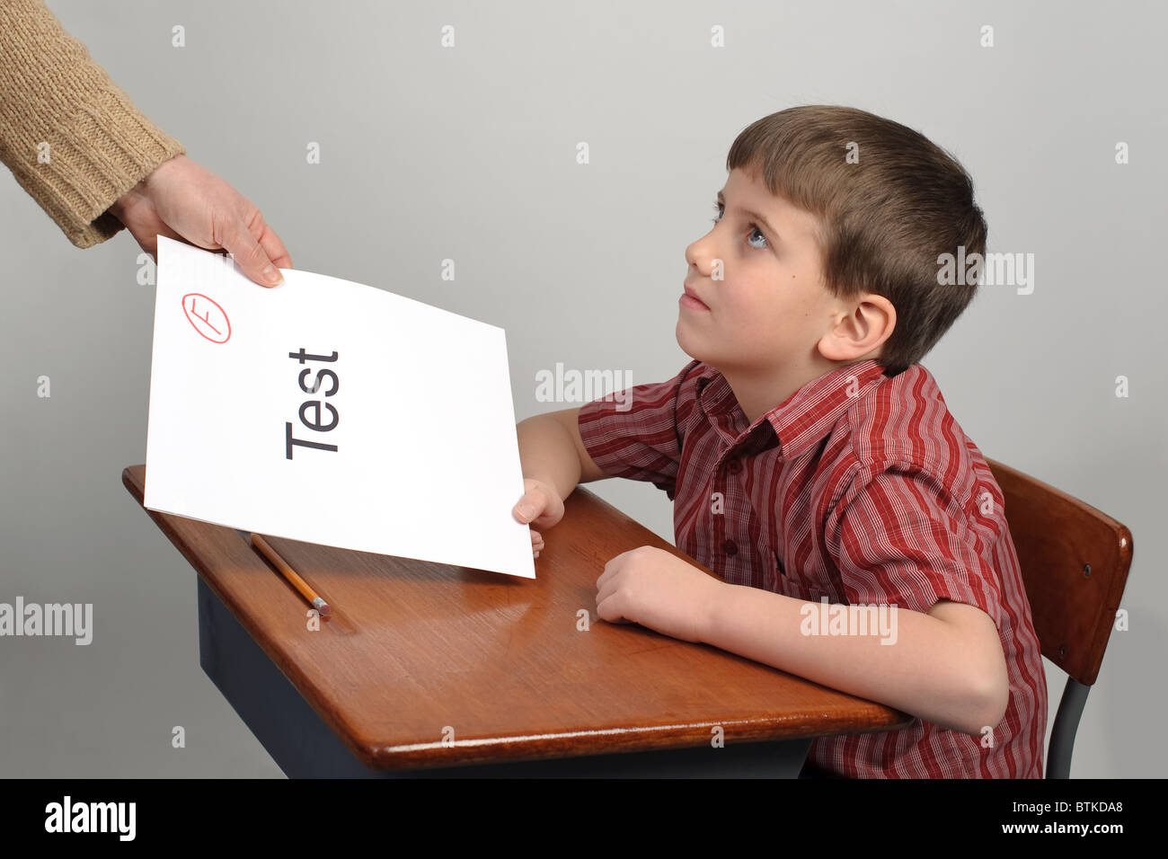 A boy receiving a failing test score Stock Photo