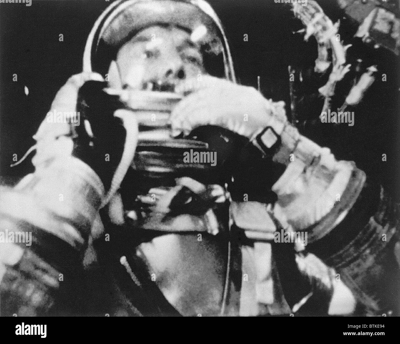 Astronaut Alan Shepard inside the Freedom 7 spacecraft during his historic fifteen and a half minute flight on May 5, 1961. Shepard is about to raise the shield in front of his face during descent. Stock Photo