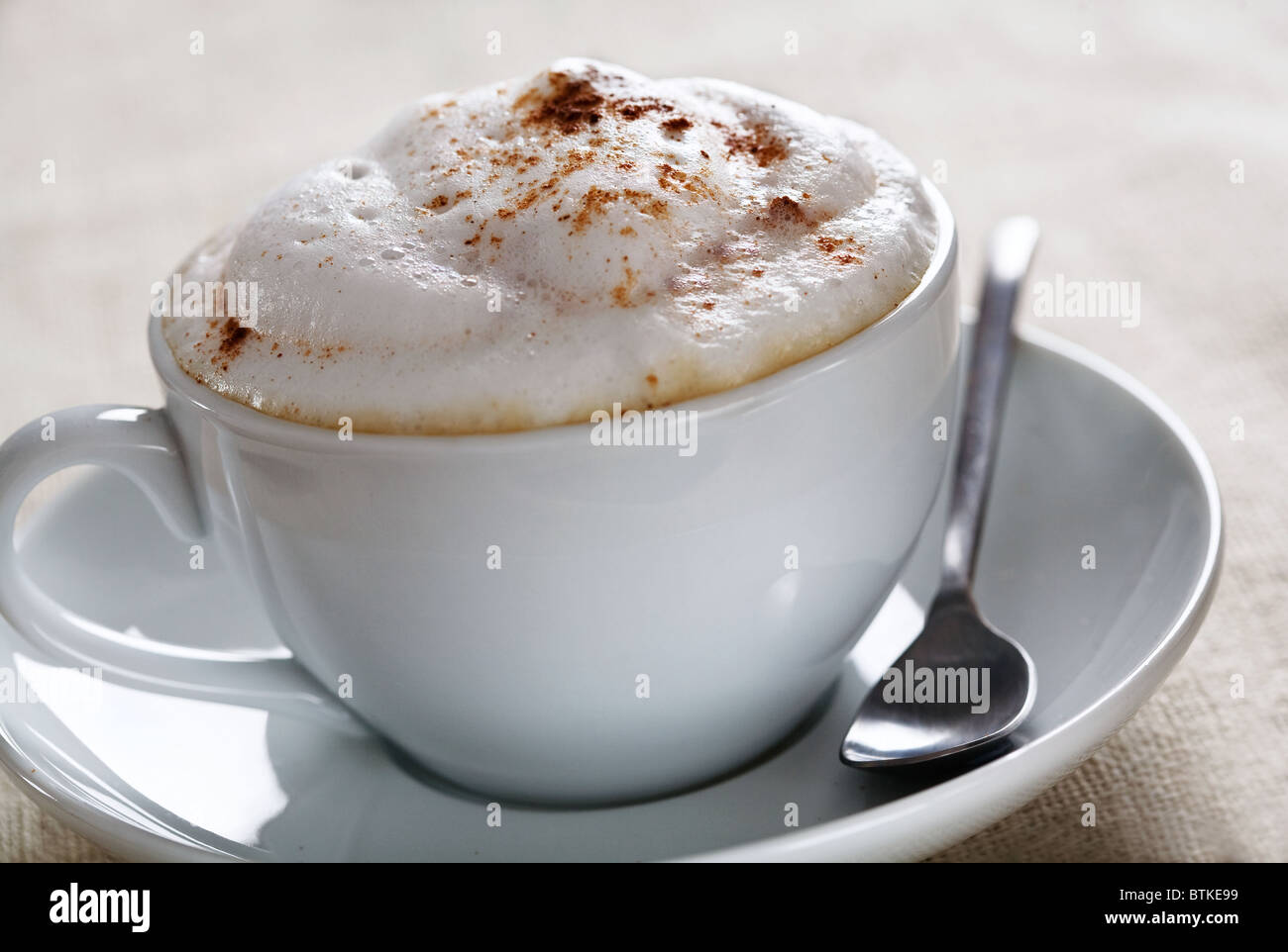 close up of creamy cappuccino with cinnamon sprinkled on top Stock Photo