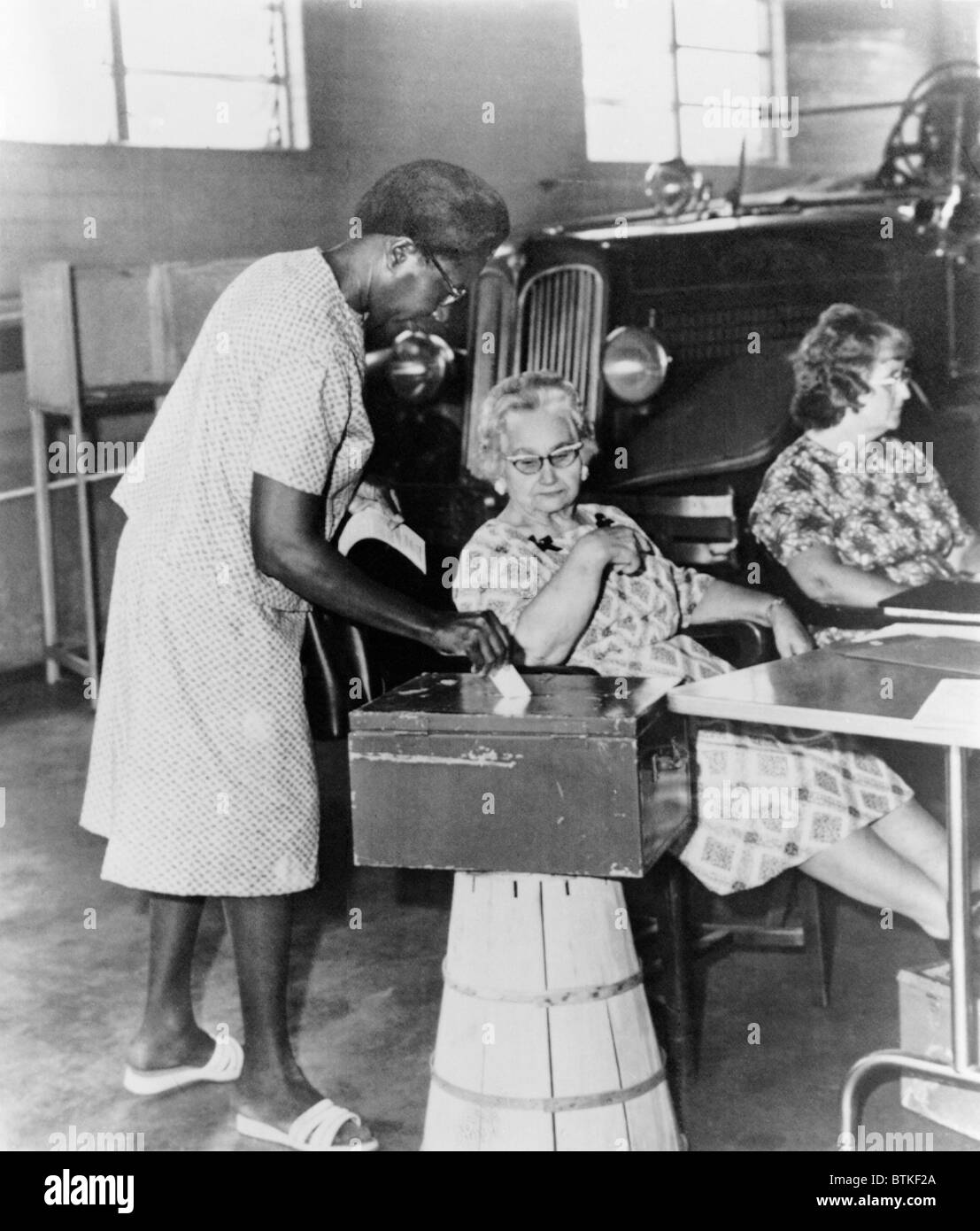 AfricanAmerican woman placing ballot in box during congressional