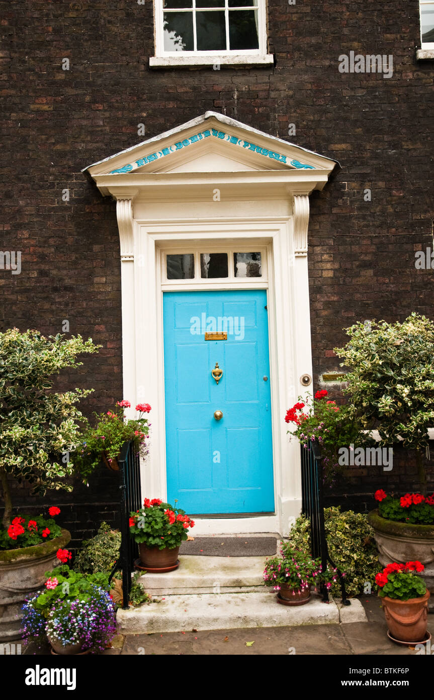 A blue ornate door with flower pots in front Stock Photo - Alamy