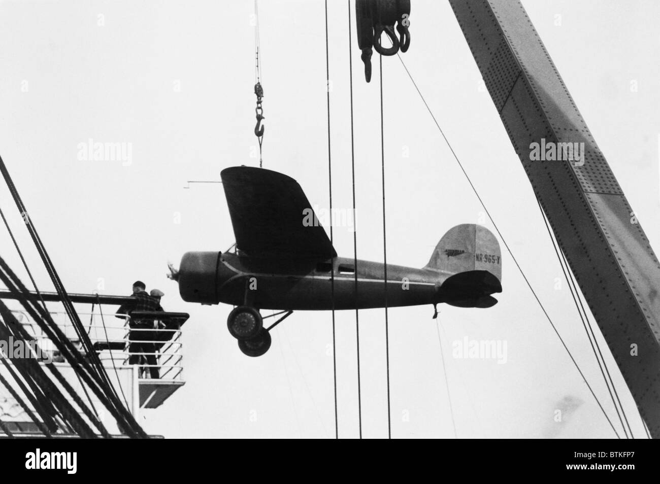 Amelia Earhart's Lockheed Vega airplane being off-loaded from the liner Lurline prior to her solo flight from Hawaii to California. January 1935. Stock Photo