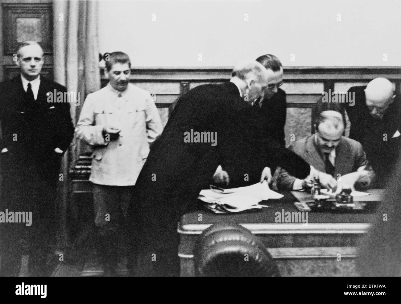 Soviet Foreign Minister Molotov signs the Nazi-Soviet Nonaggression Pact in the Kremlin on August 23, 1939. Left to right: Von Ribbentrop, Stalin, Gauss, Hilger, Molotov, von der Schulenburg. Stock Photo