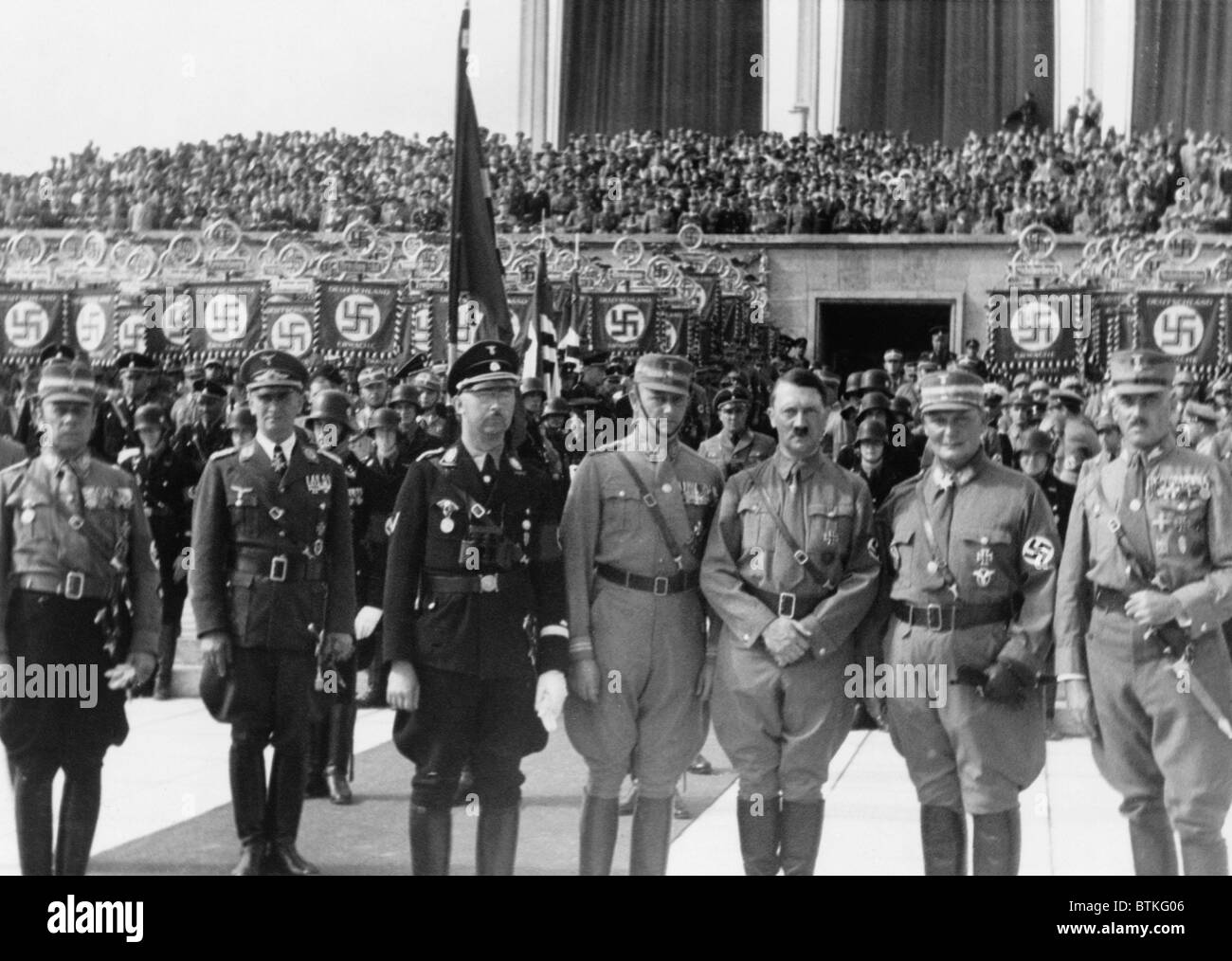 Adolf Hitler posed with Heinrich Himmler (third from left), Hermann Goring (second from right), and other Nazi officers in front of crowd, celebrating the Day of the Storm Troops, Nazi Party Day, Nuremberg. September 1935. Stock Photo