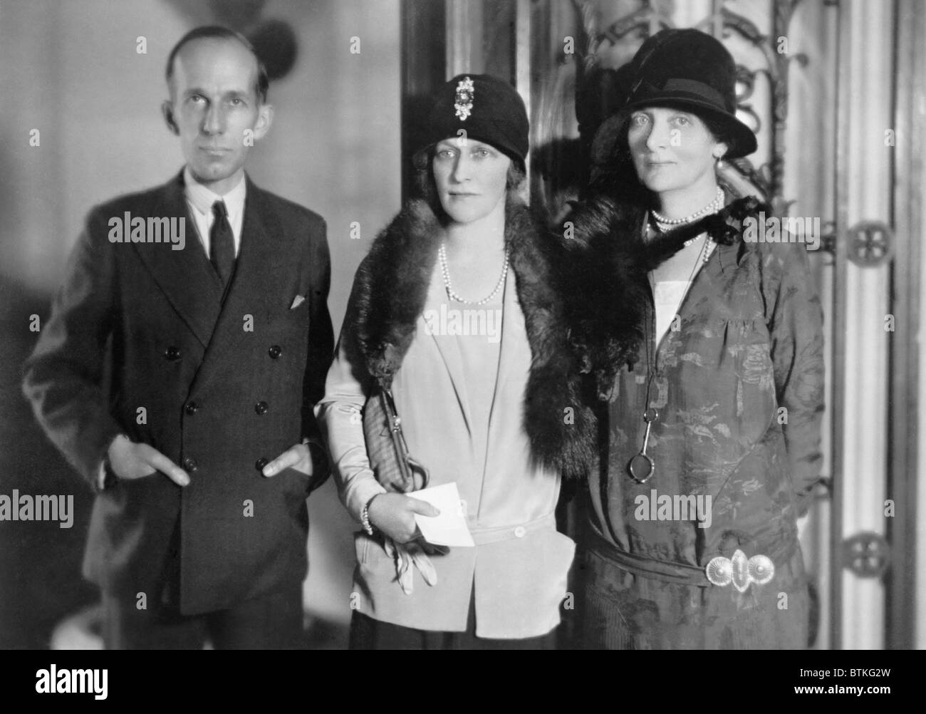 Lady Astor (center), American born British peeress, visits with Canadian minister Vincent Massey and his wife in Washington, D.C. in 1928. When elected in 1919, she was the first woman to sit in the British House of Commons. Stock Photo