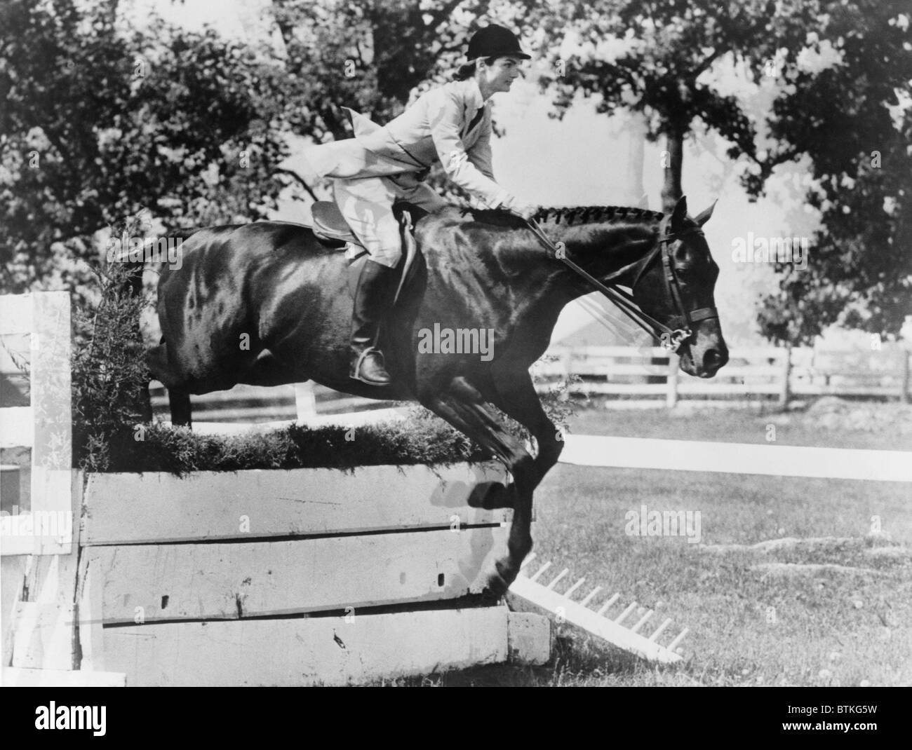 First Lady Jacqueline Kennedy, riding her horse Ninbrano, clears a hurdle at the Loudoun Hunt horse show in Leesburg, Va. May 19, 1962. Stock Photo