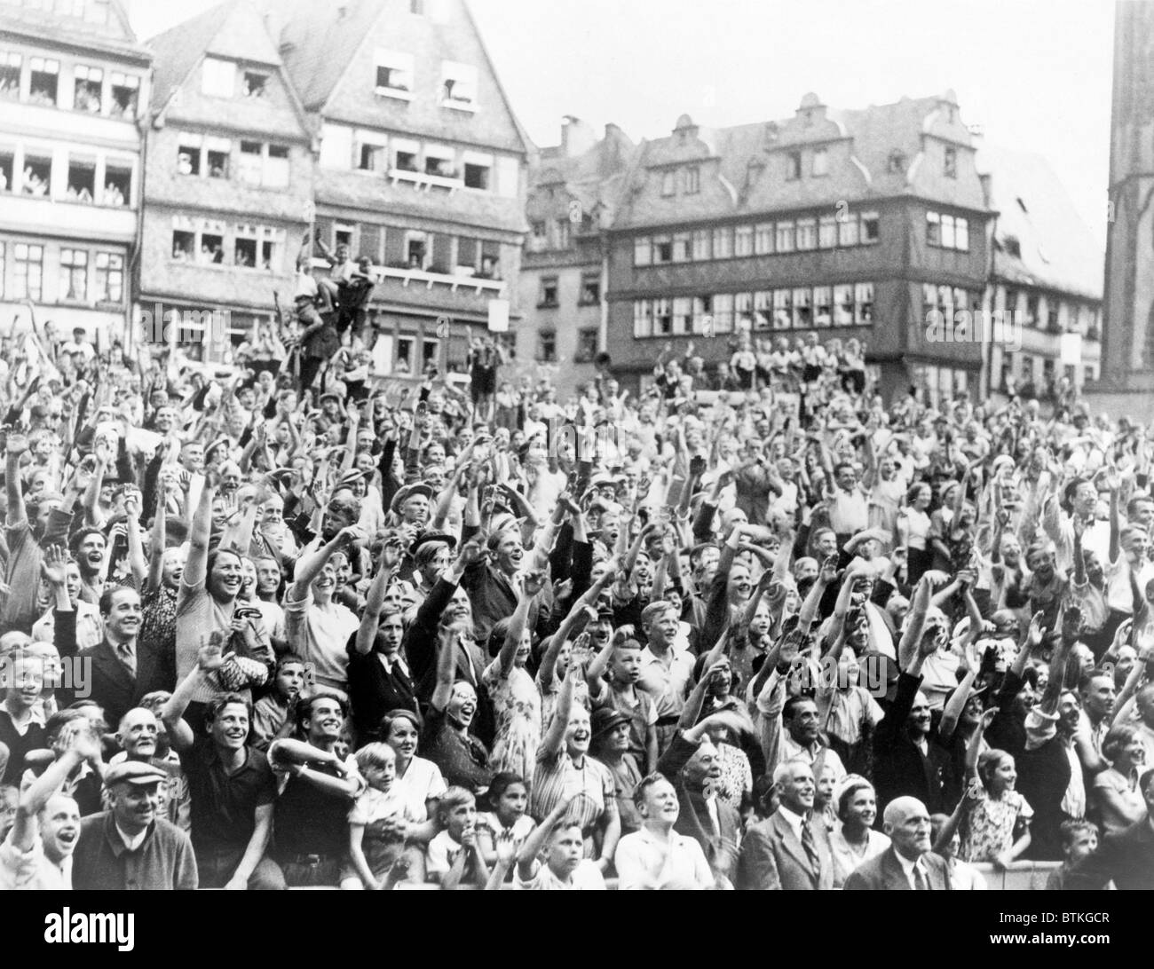 German admirers cheering Max Schmeling with a Nazi salute at City Hall in Frankfort, Germany. On June 19, 1936, Schmeling won the heavy weight championship with a 12th-round knockout of Joe Louis. Stock Photo