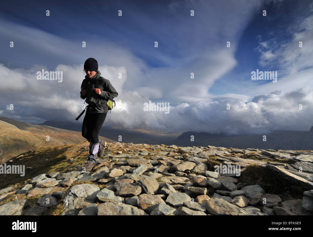 person walking in hills Stock Photo