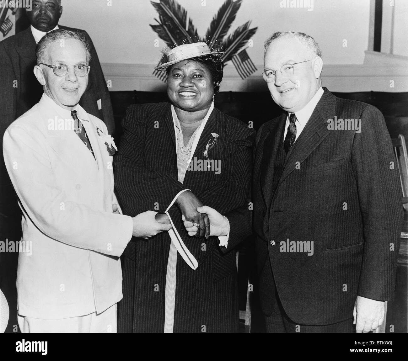 Hattie McDaniel (1895-1952), shaking hands with NAACP leaders, Walter F. White and Arthur Spingarn. McDaniel the first black performer to win an Academy Award in 1939. She had roles in over 60 films between 1932 and 1949. Ca. 1940. Stock Photo