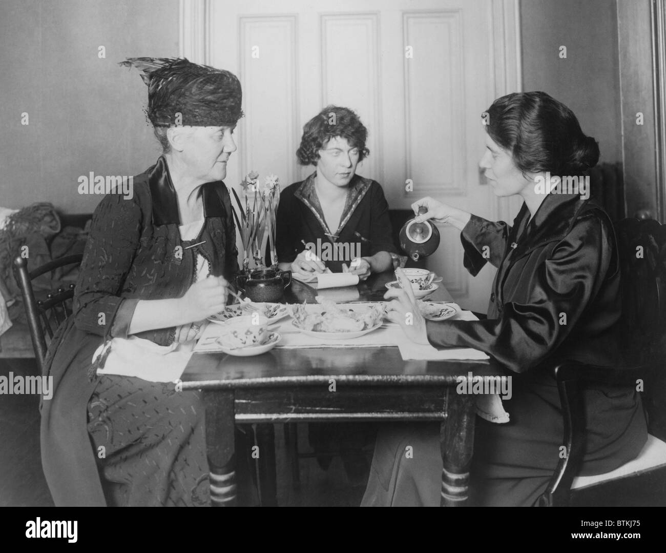 Three feminists activists in conference. Left to right: Dora Lewis Lawrence, activists and philanthropists; Pauline Floyd,(later the youngest lawyer admitted to practice before the supreme court) and Alice Paul. Ca. 1910-1920. Stock Photo