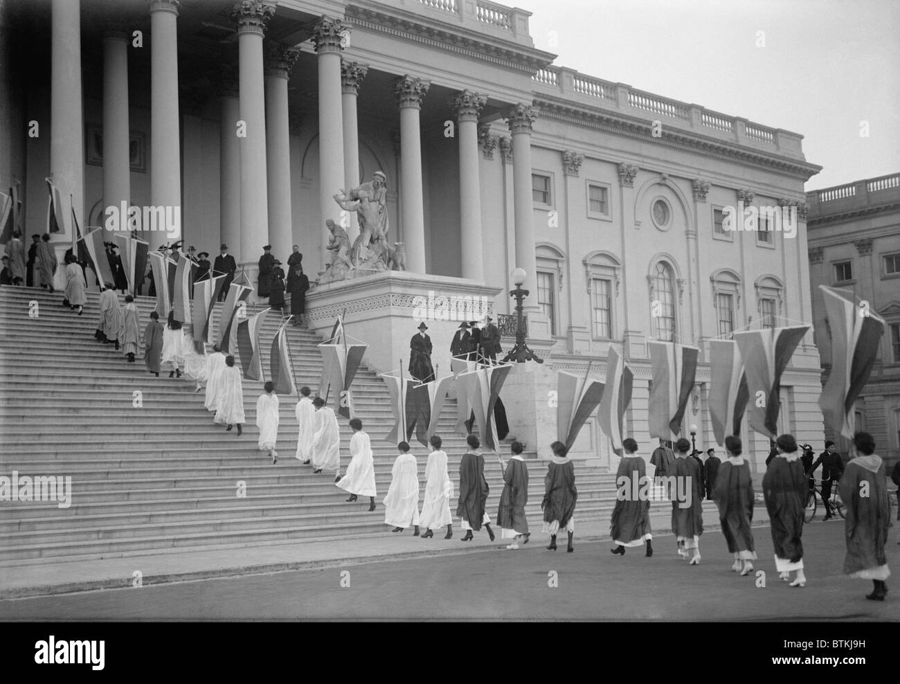 Woman Suffrage demonstration with banners at the U.S. Capitol in 1917. View of Procession ascending Capitol steps. Stock Photo