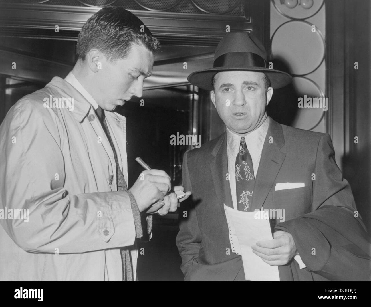 Mickey Cohen (1913-1976), speaking with reporter in New York City on May 20, 1957. In the 1950's, Cohen was a celebrity gangster with many Hollywood friends, Stock Photo